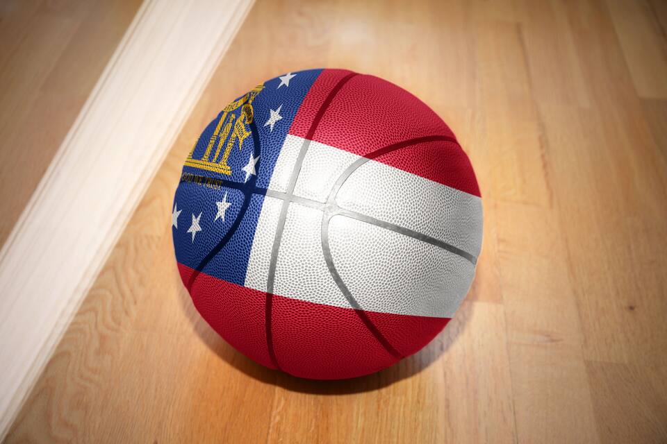 A basketball with a flag design on a wooden floor.