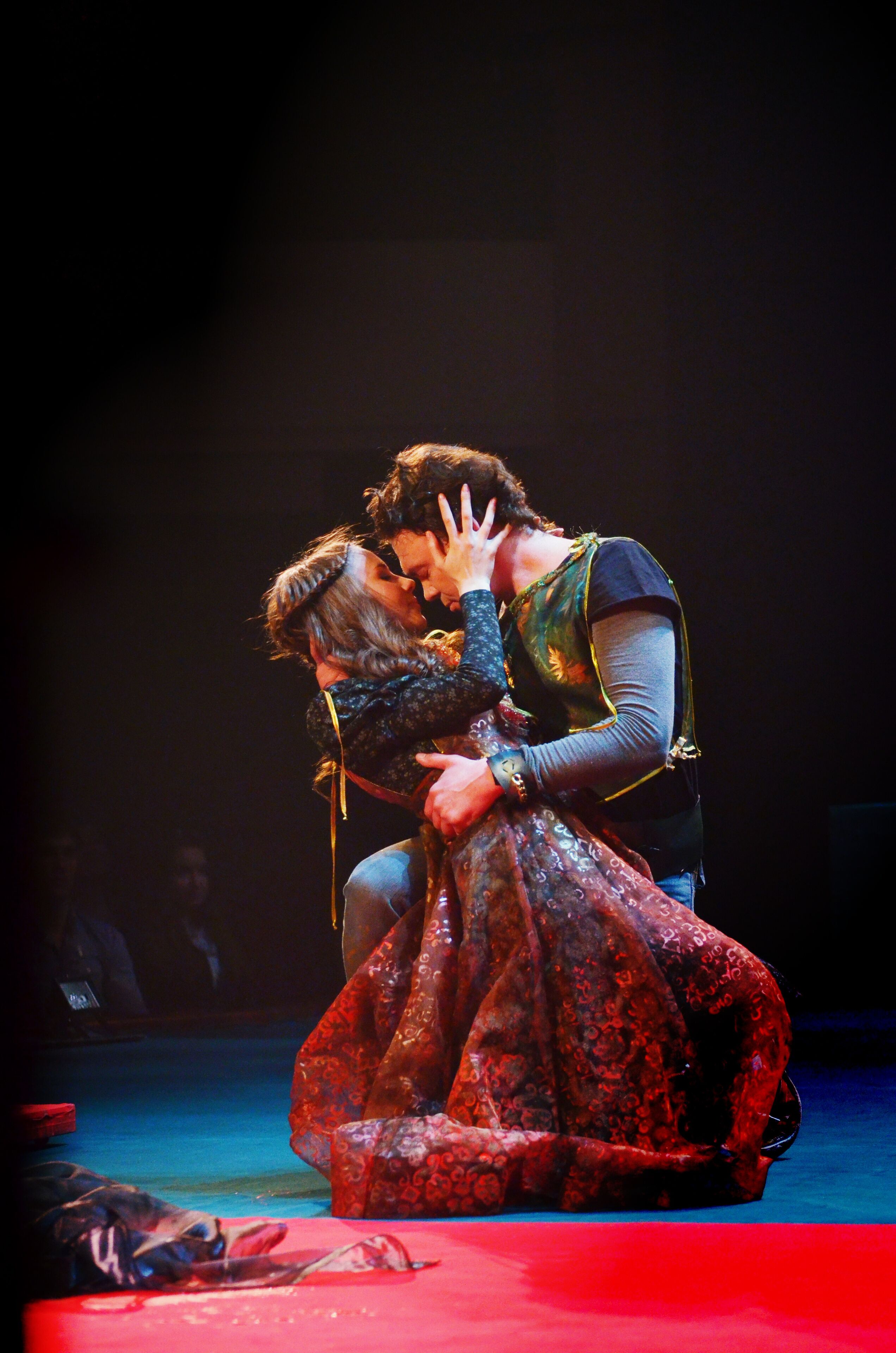 Theater actors in costumes play in the play