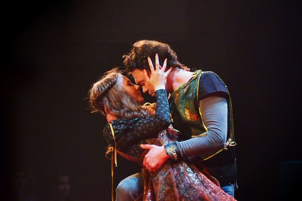 Theater actors in costumes play in the play