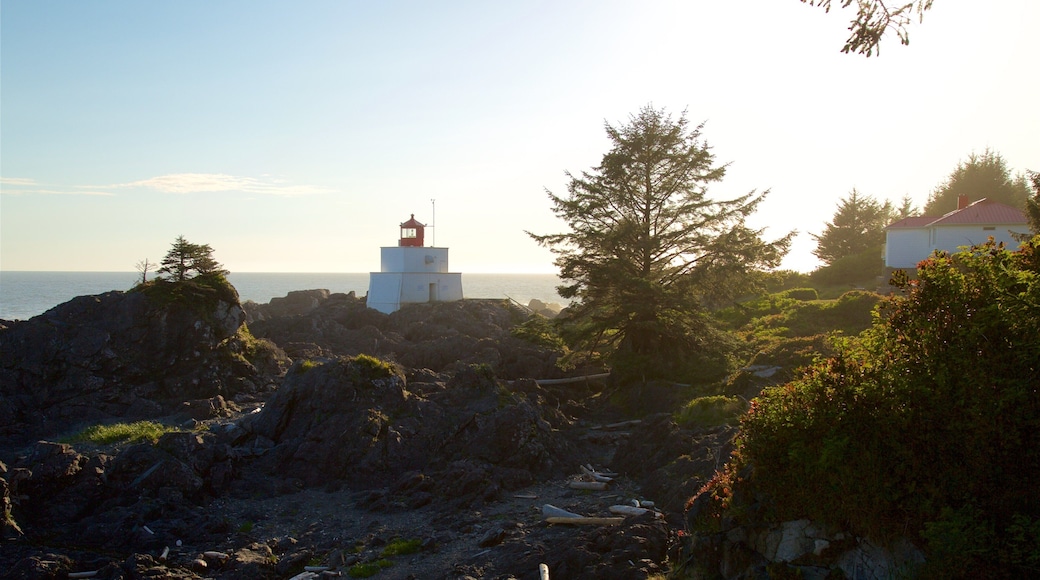 Amphitrite Point Lighthouse featuring a sunset, a lighthouse and rocky coastline