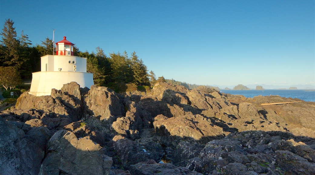 Amphitrite Point Lighthouse featuring a lighthouse, a sunset and rugged coastline