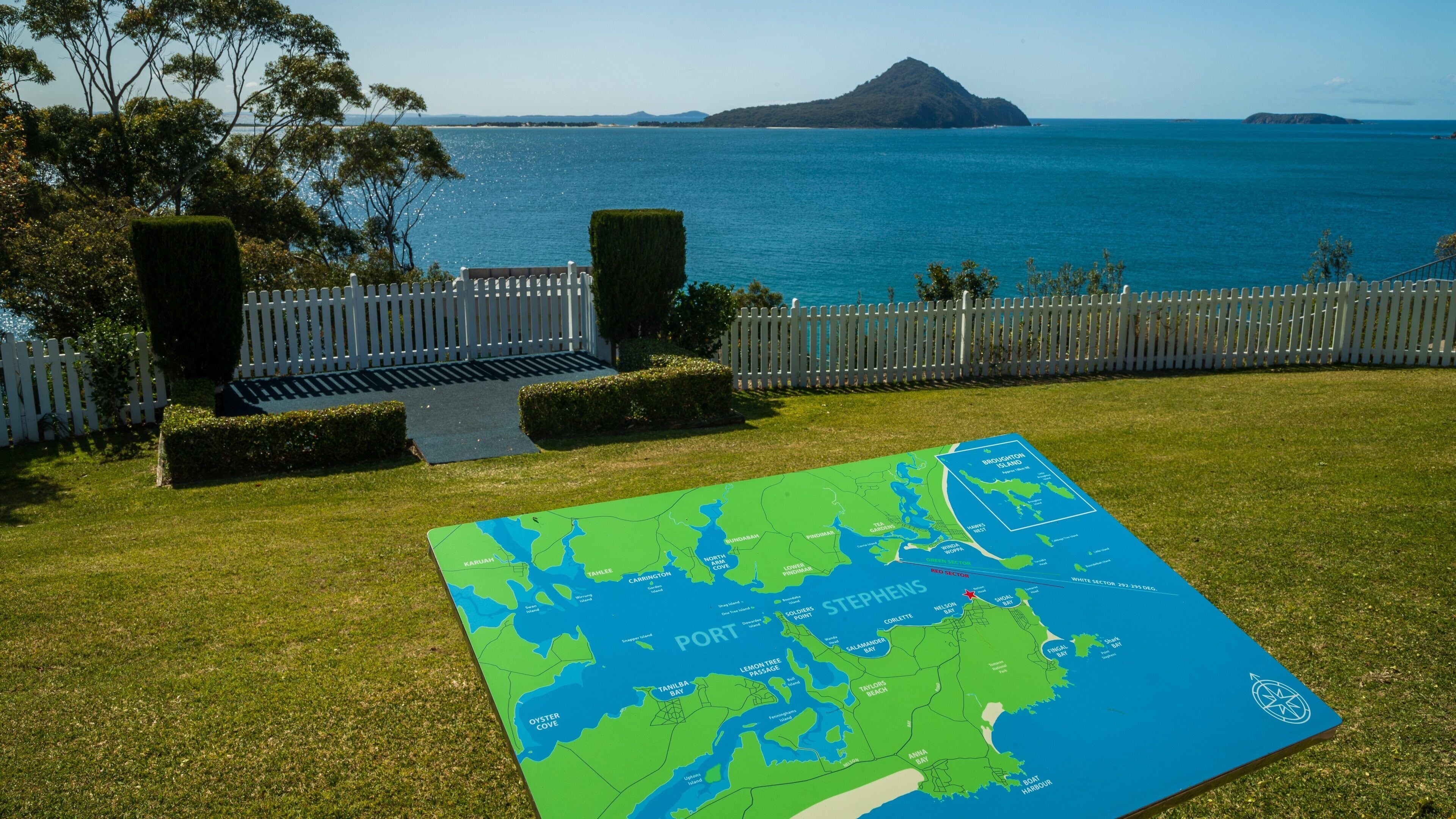 Nelson Head Lighthouse which includes signage and general coastal views