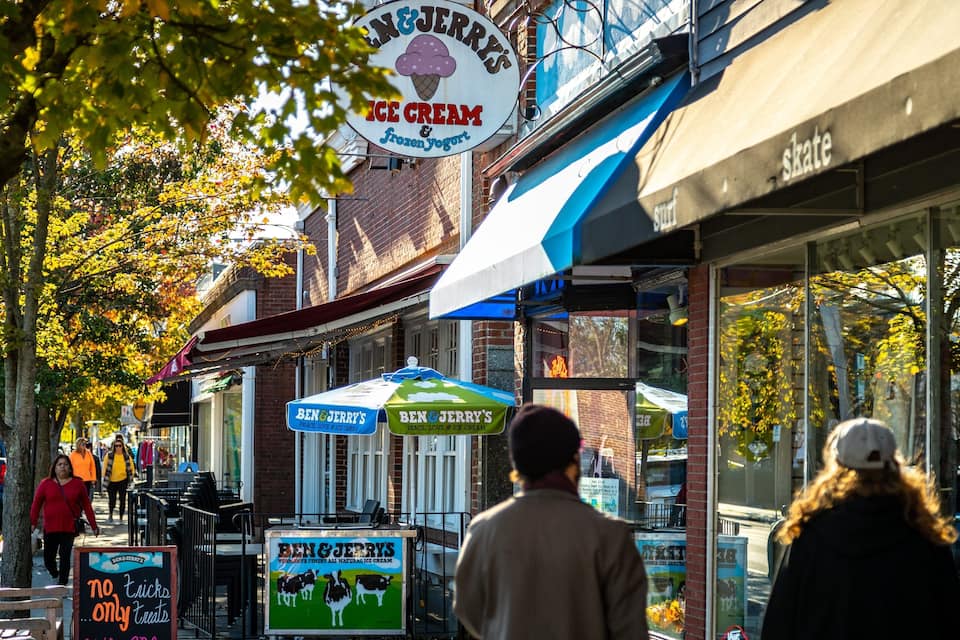 A street with ice cream shops and a skate shop.