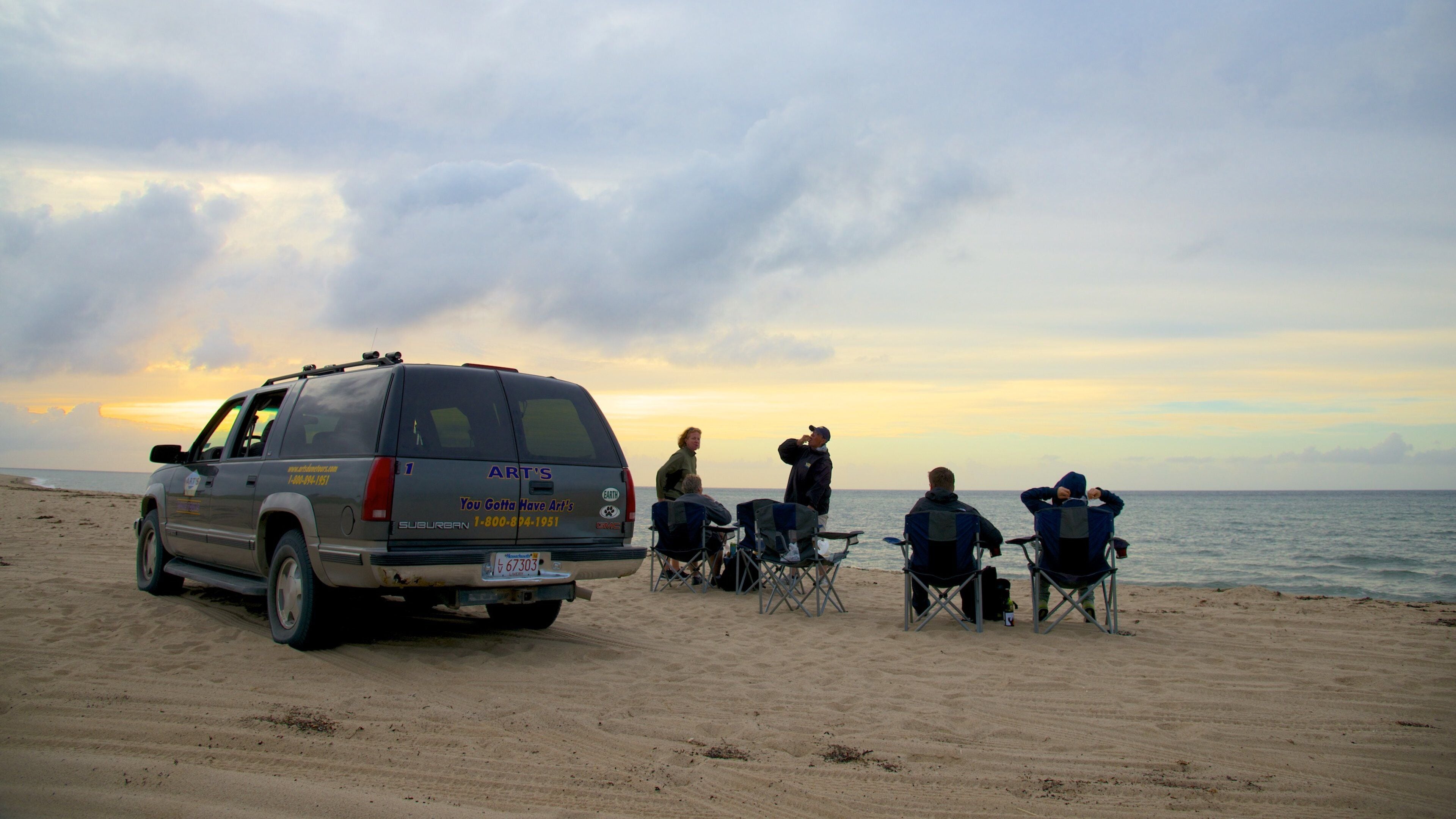 Race Point Beach showing a beach, a sunset and 4 wheel driving