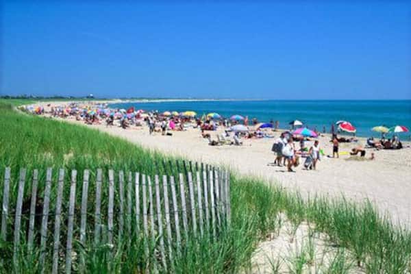 AXE420 Sunbathers and dune landscape on Surfside Beach on the seaward coast of the island of Nantucket, Massachusetts, New England, USA