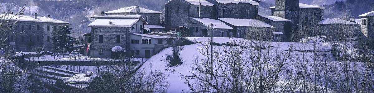 Piazza al Serchio snowy village and Apuan mountains in winter. Garfagnana, Tuscany, Italy
