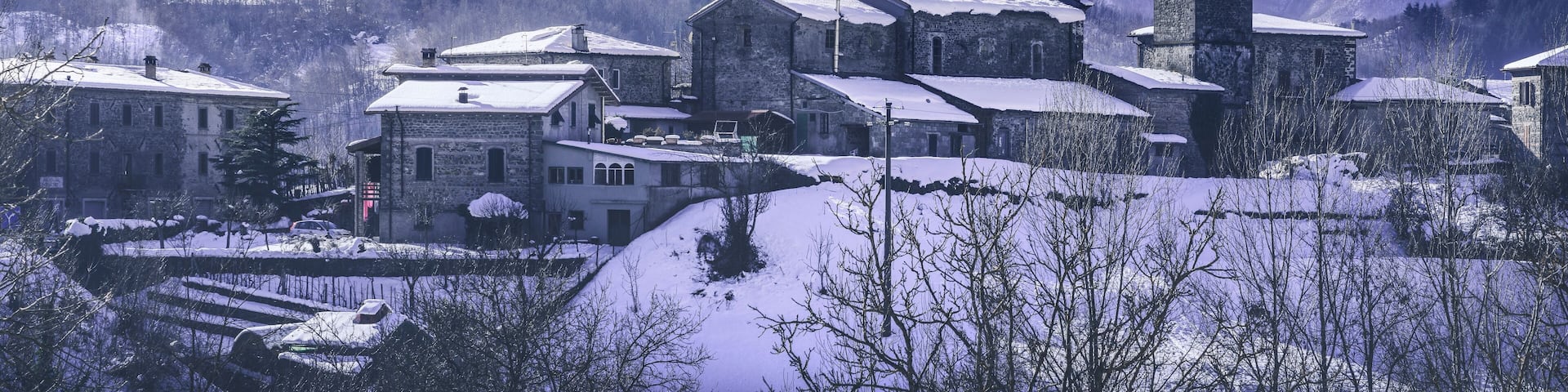 Piazza al Serchio snowy village and Apuan mountains in winter. Garfagnana, Tuscany, Italy