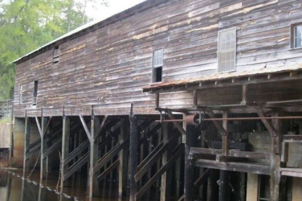 A wooden structure with a staircase leading down to a body of water.
