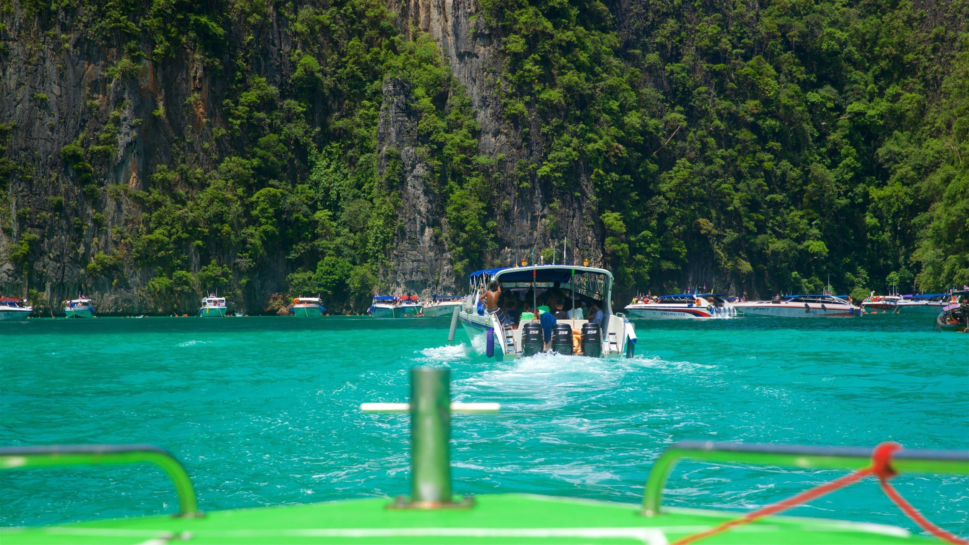 Maya Bay showing a bay or harbour, boating and tropical scenes