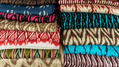 Scarves or Macanas at the market, traditional handcraft and design for Gualaceo canton, Azuay province, made by using technique called Ikat, colorful fabrics background. Cuenca, Ecuador