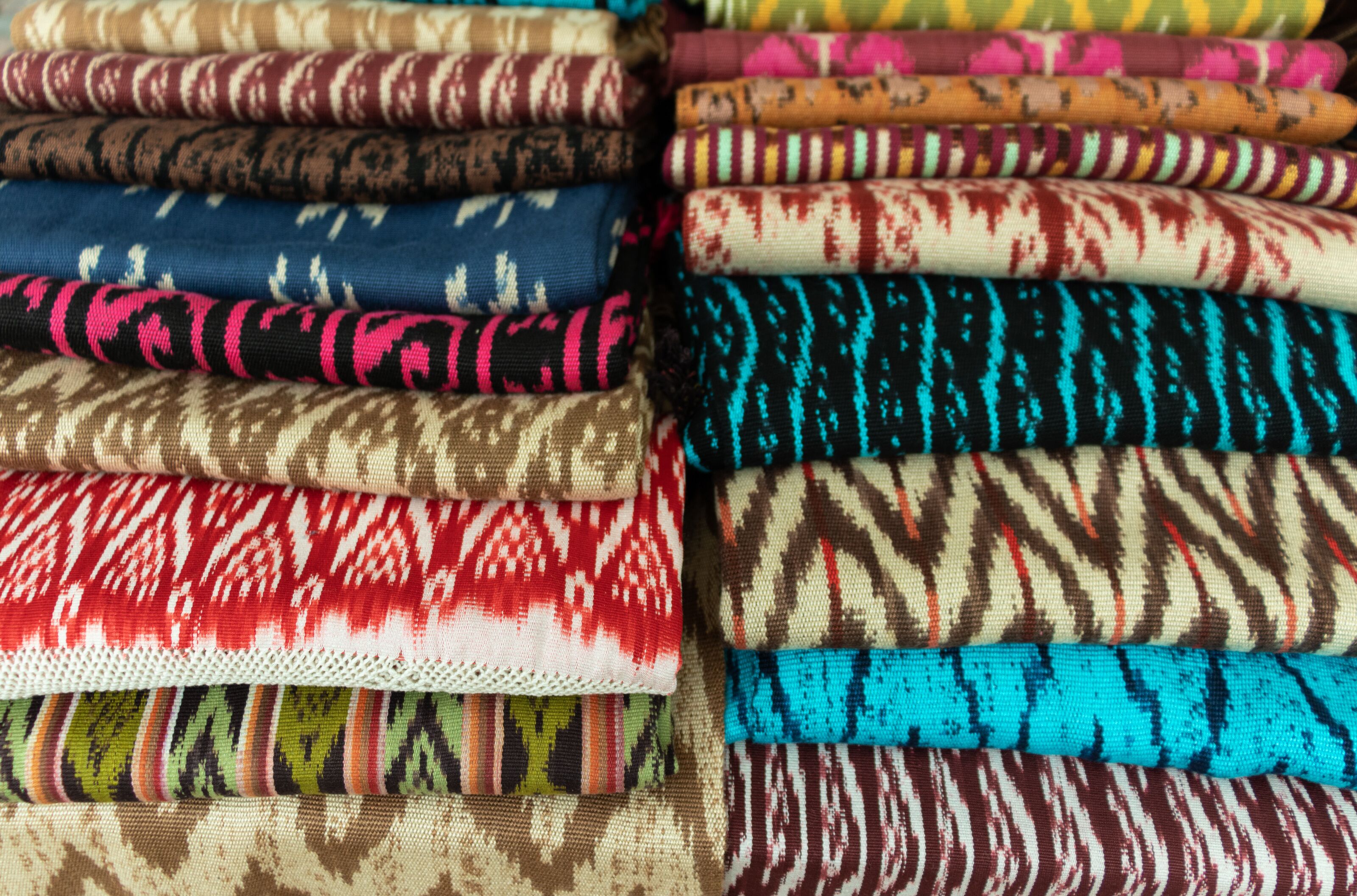 A variety of colorful fabrics with different patterns and textures.