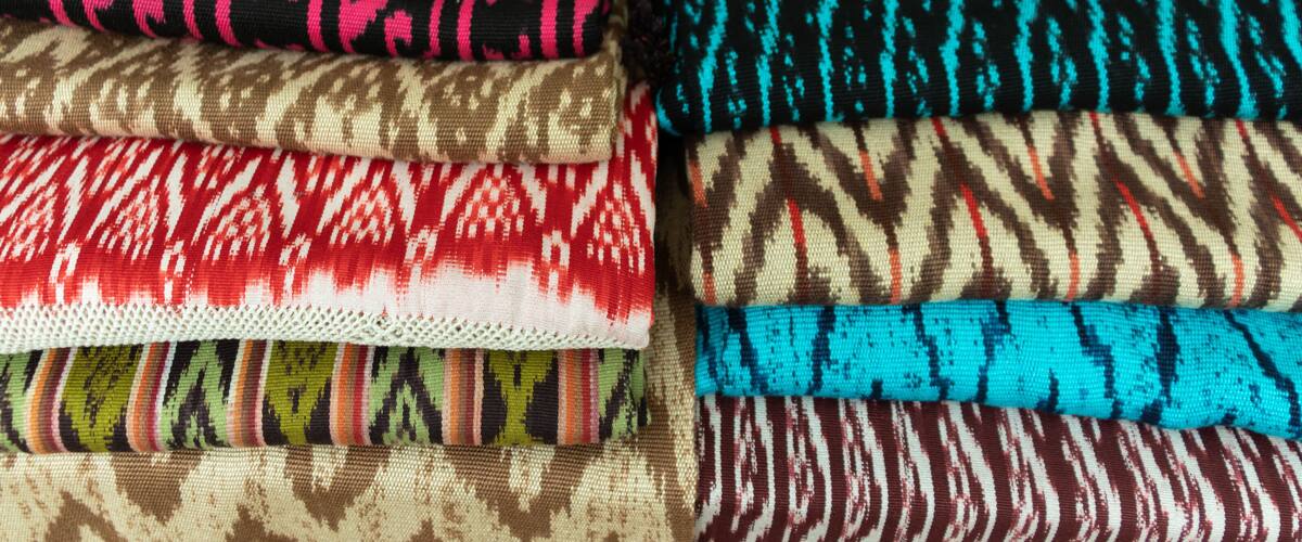 A variety of colorful fabrics with different patterns and textures.