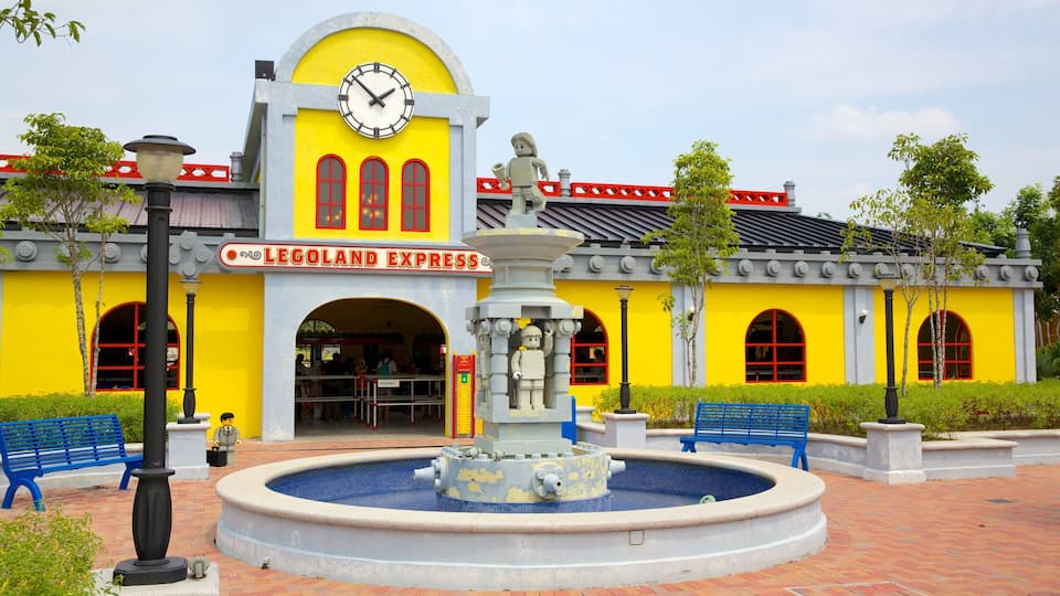 Johor Bahru showing a fountain, rides and signage
