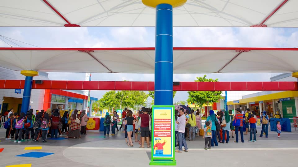 Johor Bahru featuring signage as well as a large group of people
