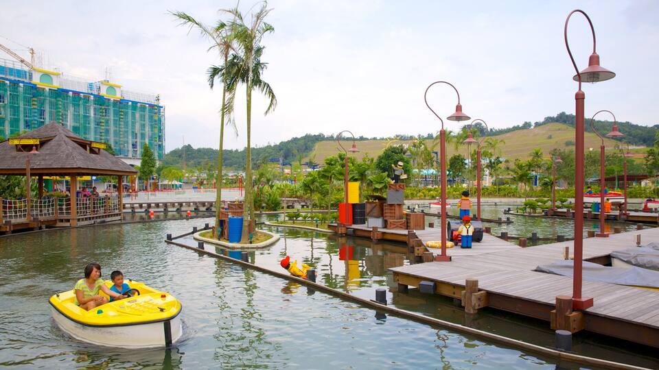A water park with boats, wooden docks, and palm trees.