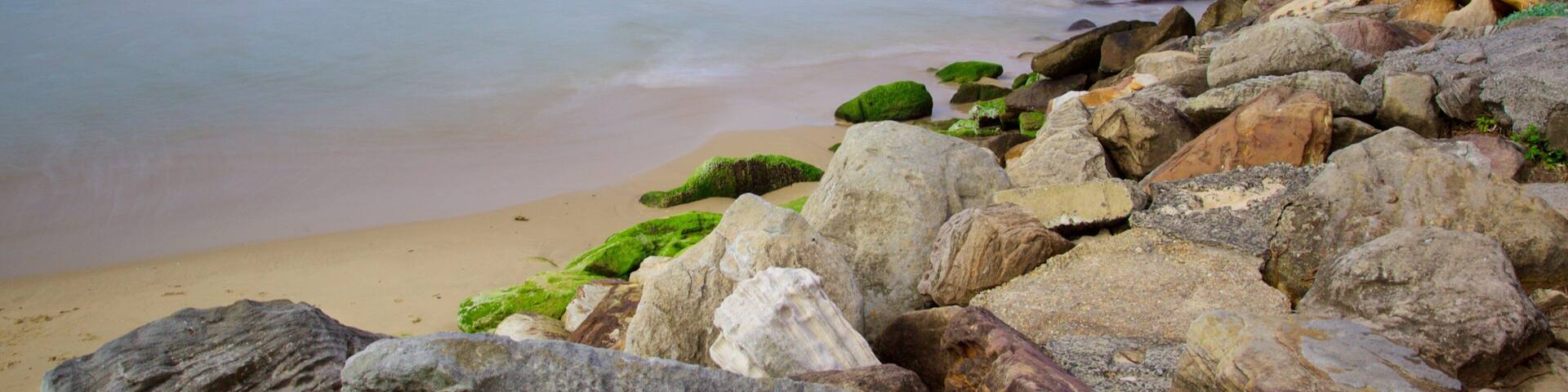 A rocky beach with waves crashing onto the shore.