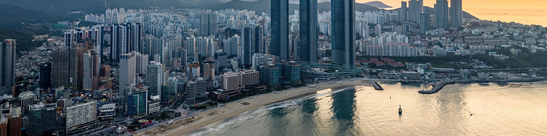 Sunrise Over Haeundae Beach and LCT The Sharp: Aerial View of Busan's Iconic Coastline
