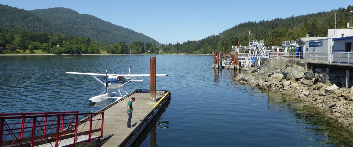 A lake with a dock, a small airplane, and a building labeled "Saanich Island."