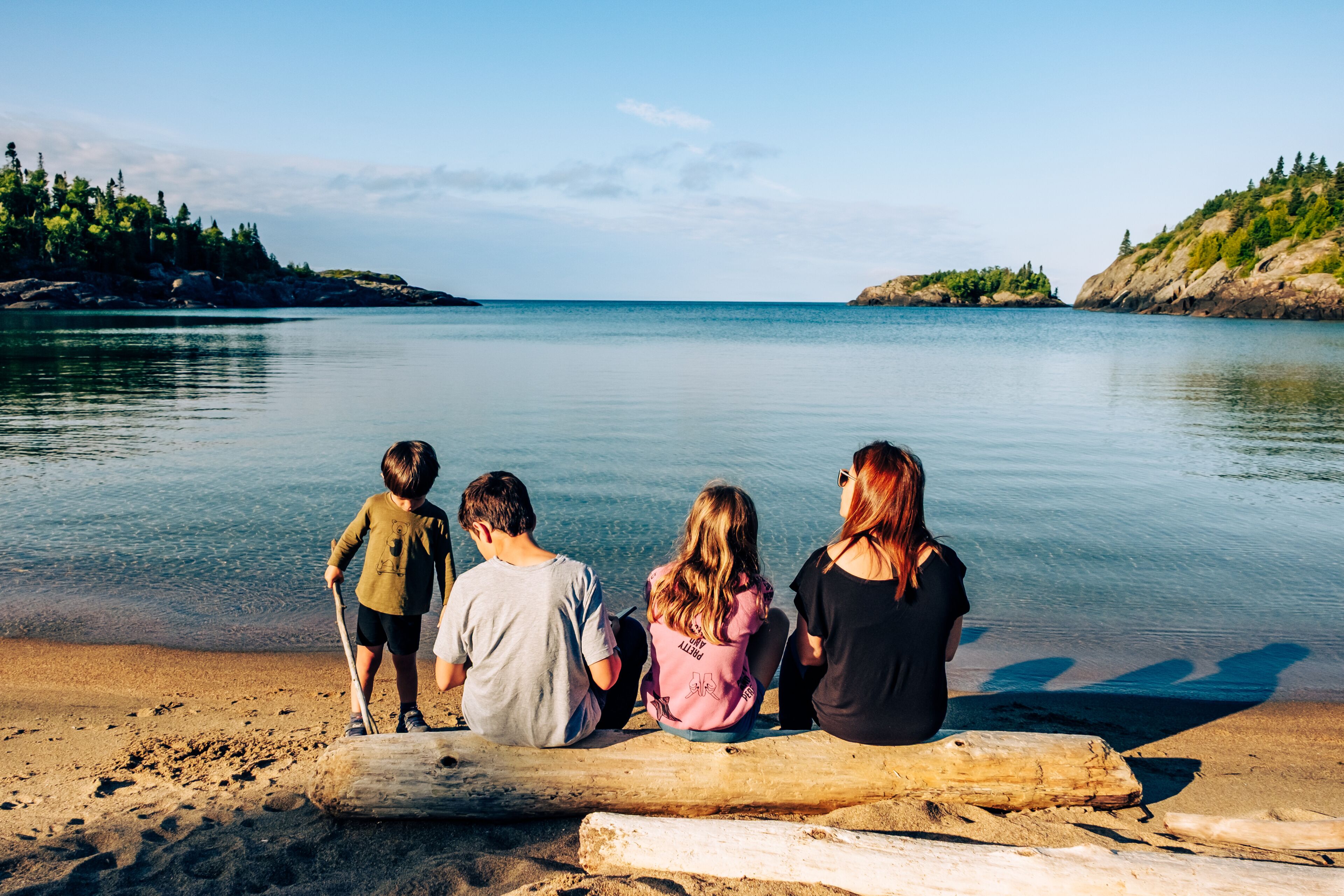 Family on the shores of Lake Superior, Pukaskwa National Park, Ontario, Canada
