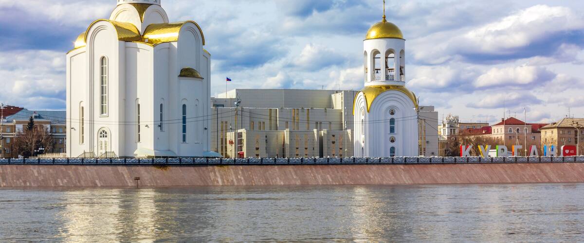The view of the Tobol River and Holy Trinity Church in Kurgan, Russia.