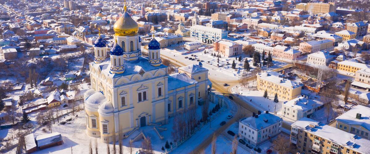 Aerial view of Yelets winter cityscape and Orthodox Ascension Cathedral covered with snow, Russia