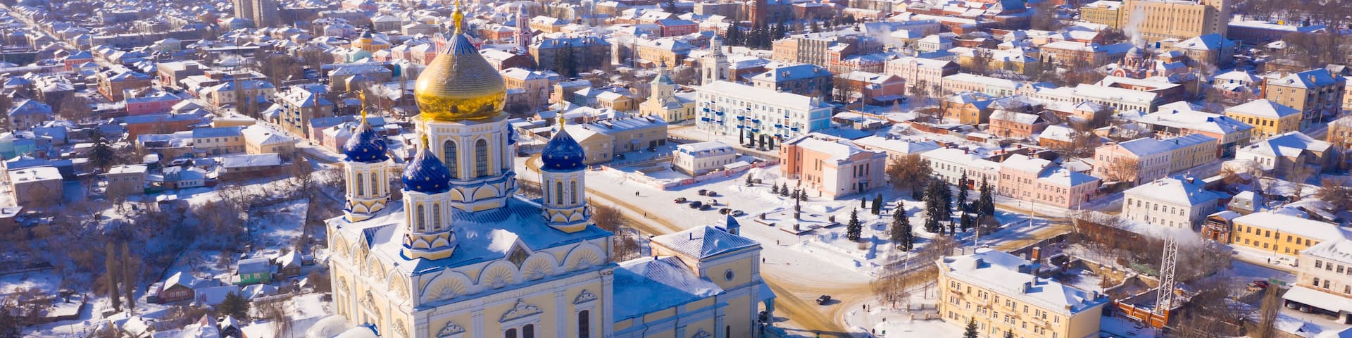 Aerial view of Yelets winter cityscape and Orthodox Ascension Cathedral covered with snow, Russia