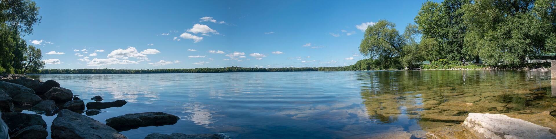 A panoramic view of the crystal clear waters of Lake on a Mountain near Picton in Prince Edward County, Ontario as they glisten in the morning sun on a beautiful late summer day.