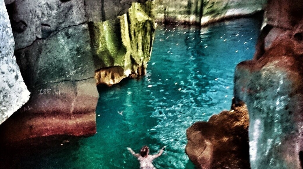 You can swim into these beautiful limestone caves, and under the ledge into another pitch black cave. It's an amazing experience.