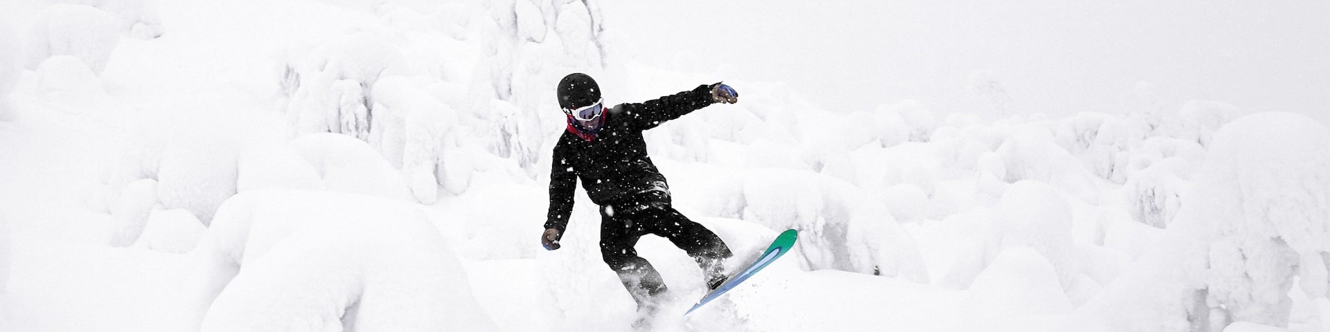 A person snowboarding on a snowy slope.