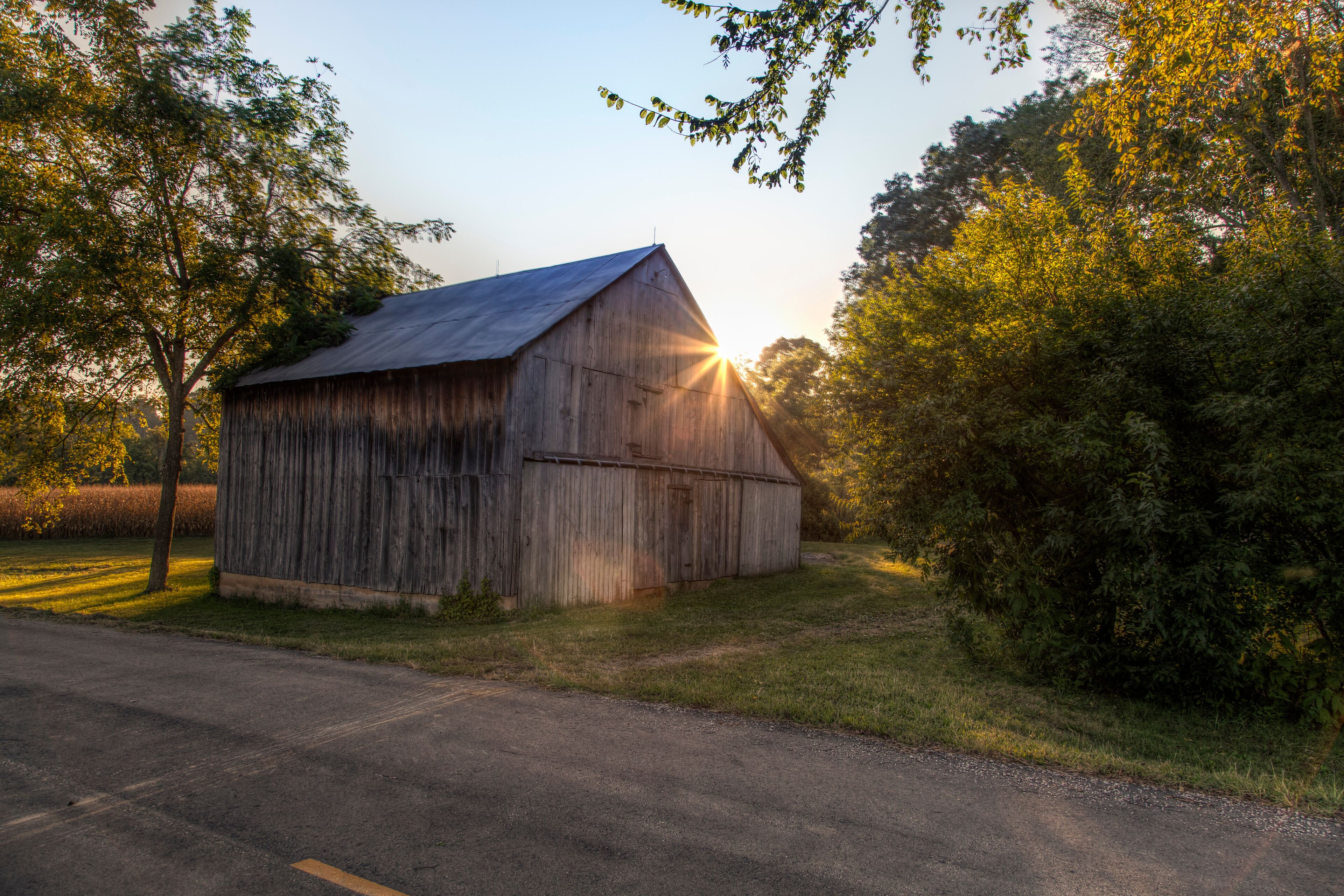 Sunlight burst through the roof a barn on a Autumn evening in Perry County, Missouri 