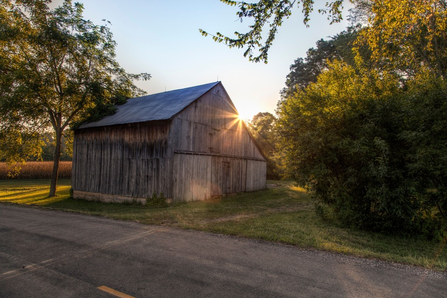 Sunlight burst through the roof a barn on a Autumn evening in Perry County, Missouri