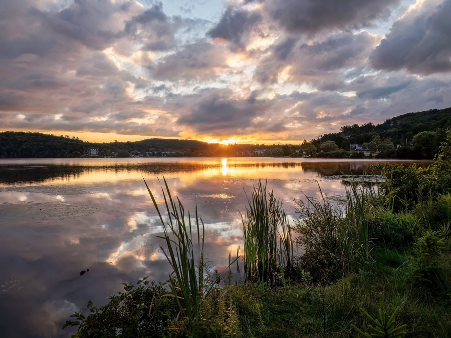 During the summer a sunrise appears across Head Lake in Haliburton, Ontario, Canada