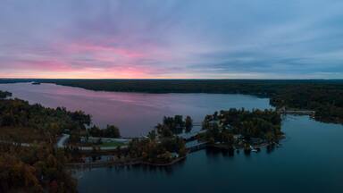 Aerial Panoramic view of Moira Lake during a striking and colorful sunrise. Taken in Madoc, Ontario, Canada.