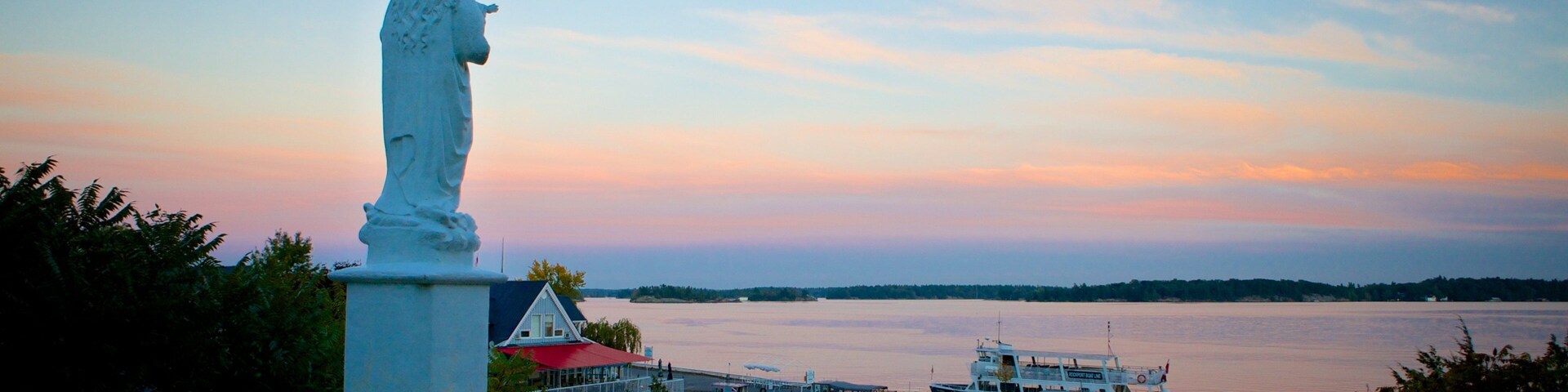 Rockport showing a lake or waterhole, a statue or sculpture and a sunset
