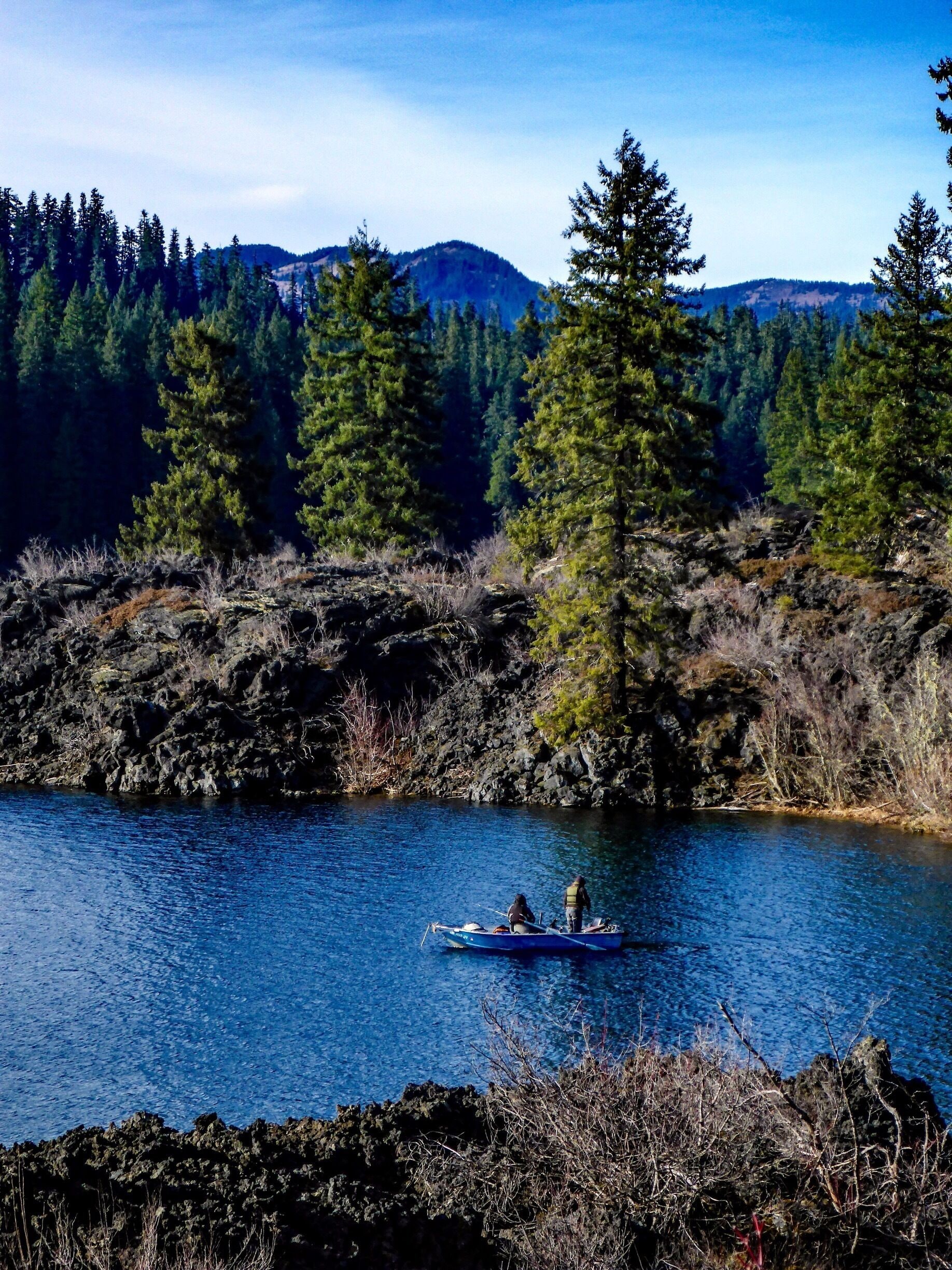 Fishermen test the waters of a cove lined entirely with obsidian.  The lake is regularly stocked with prized Cuttthroat Trout.