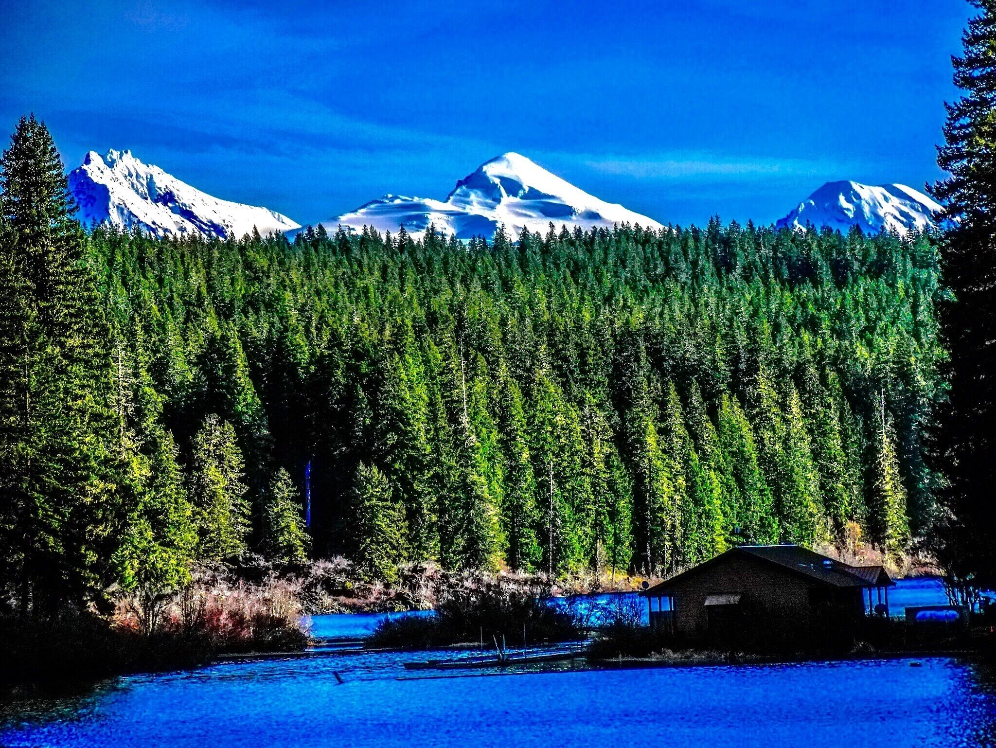 Three-fingered Jack and the Three Sisters as seen from the northwest corner of Clear Lake.

Note:  this posting originally stated the location as the southeast corner of the lake (as if lakes have corners, right?), but it was essentially backwards.  Though my dad was a navigator for the air force in his younger days, I apparently never inherited the gene.