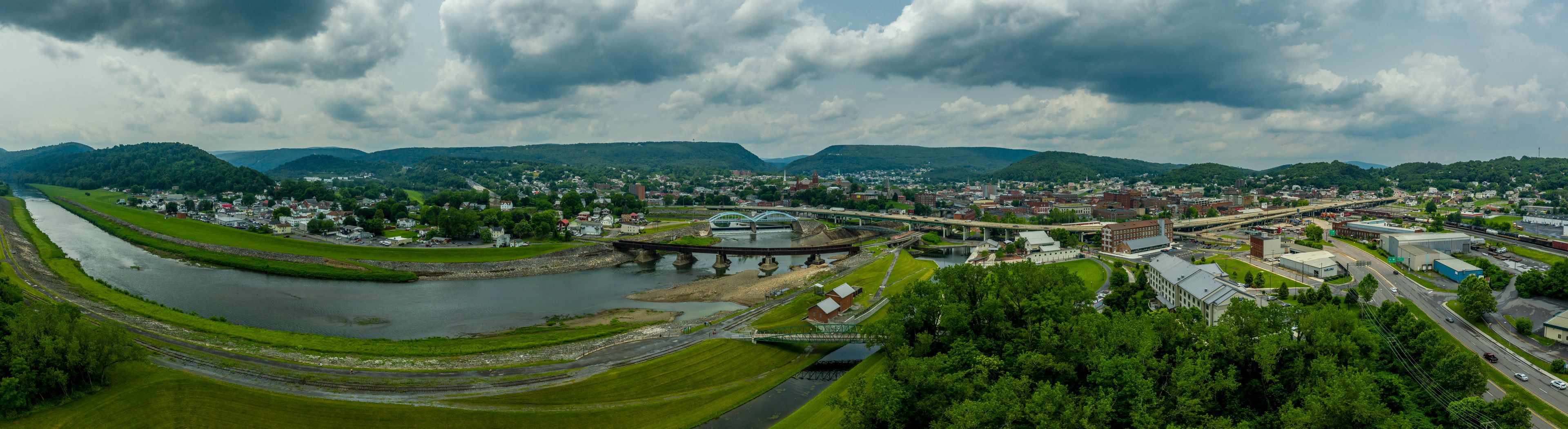 A river, a bridge, a town, and surrounding hills.