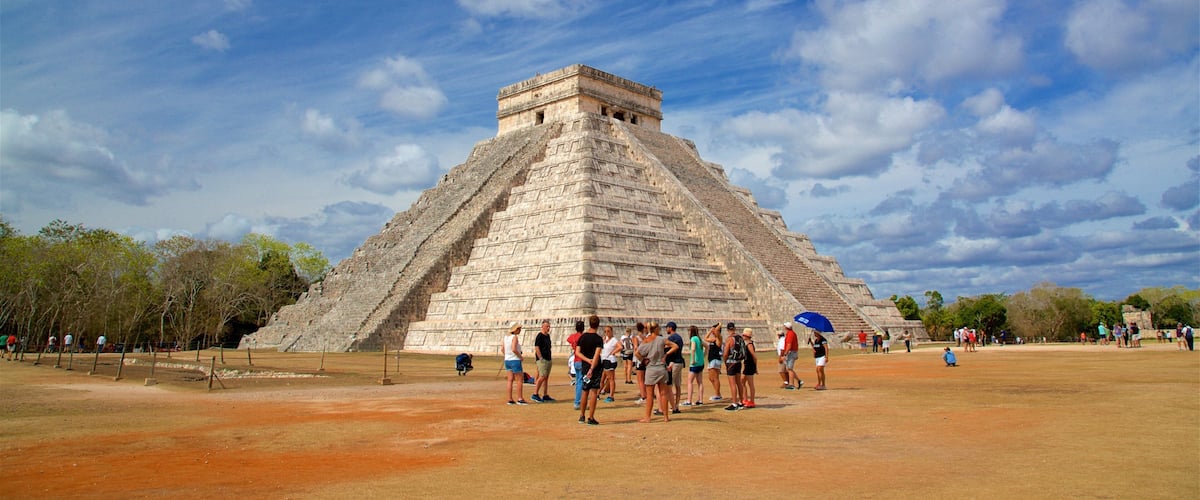 Pyramid of Kukulkan showing heritage architecture as well as a small group of people