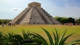 Pyramid of Kukulkan which includes heritage architecture and a park as well as a small group of people