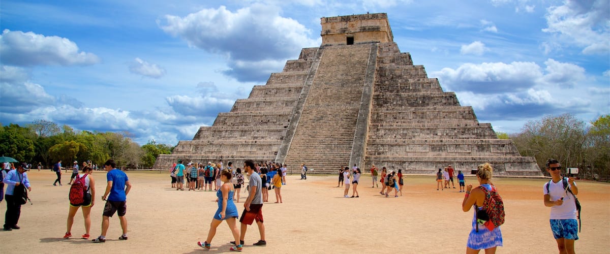Pyramid of Kukulkan featuring heritage architecture as well as a small group of people
