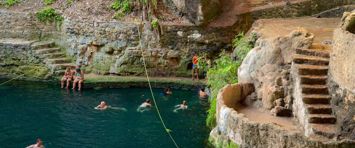 Cenote Zaci which includes swimming and a lake or waterhole as well as a small group of people