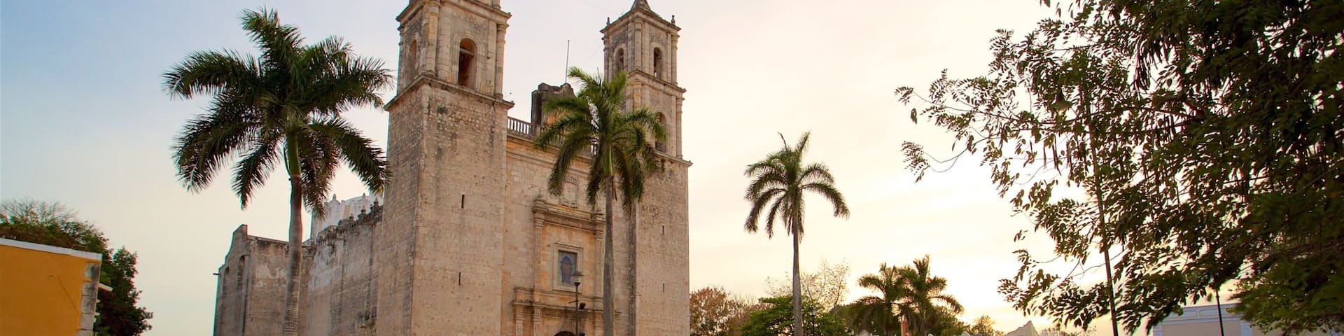 Cathedral of San Gervasio featuring heritage architecture and a sunset