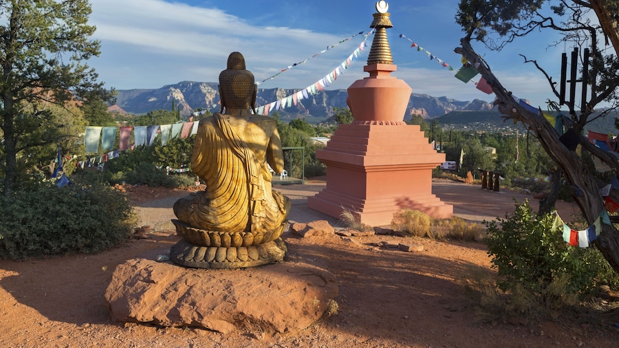 Amitabha Stupa, Buddha Statue and Prayer Flags with Distant Red Rock Landscape in Peace Park, Sedona Arizona
