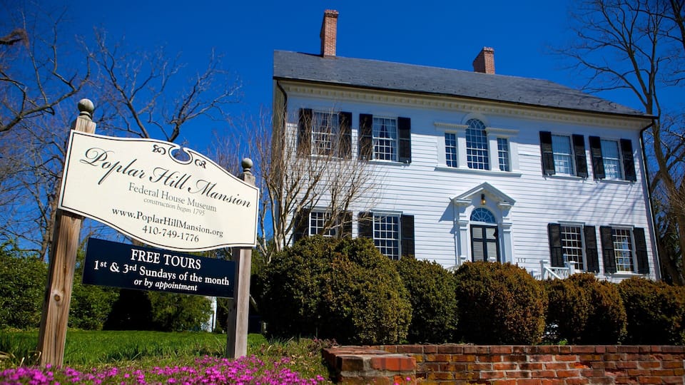 A historic building with a sign indicating Poplar Hill Mansion, a Federal House Museum, and free tours available.