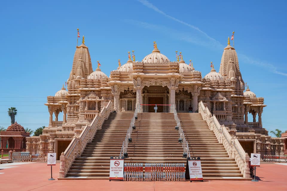 A large, ornate temple with multiple domes and intricate carvings.