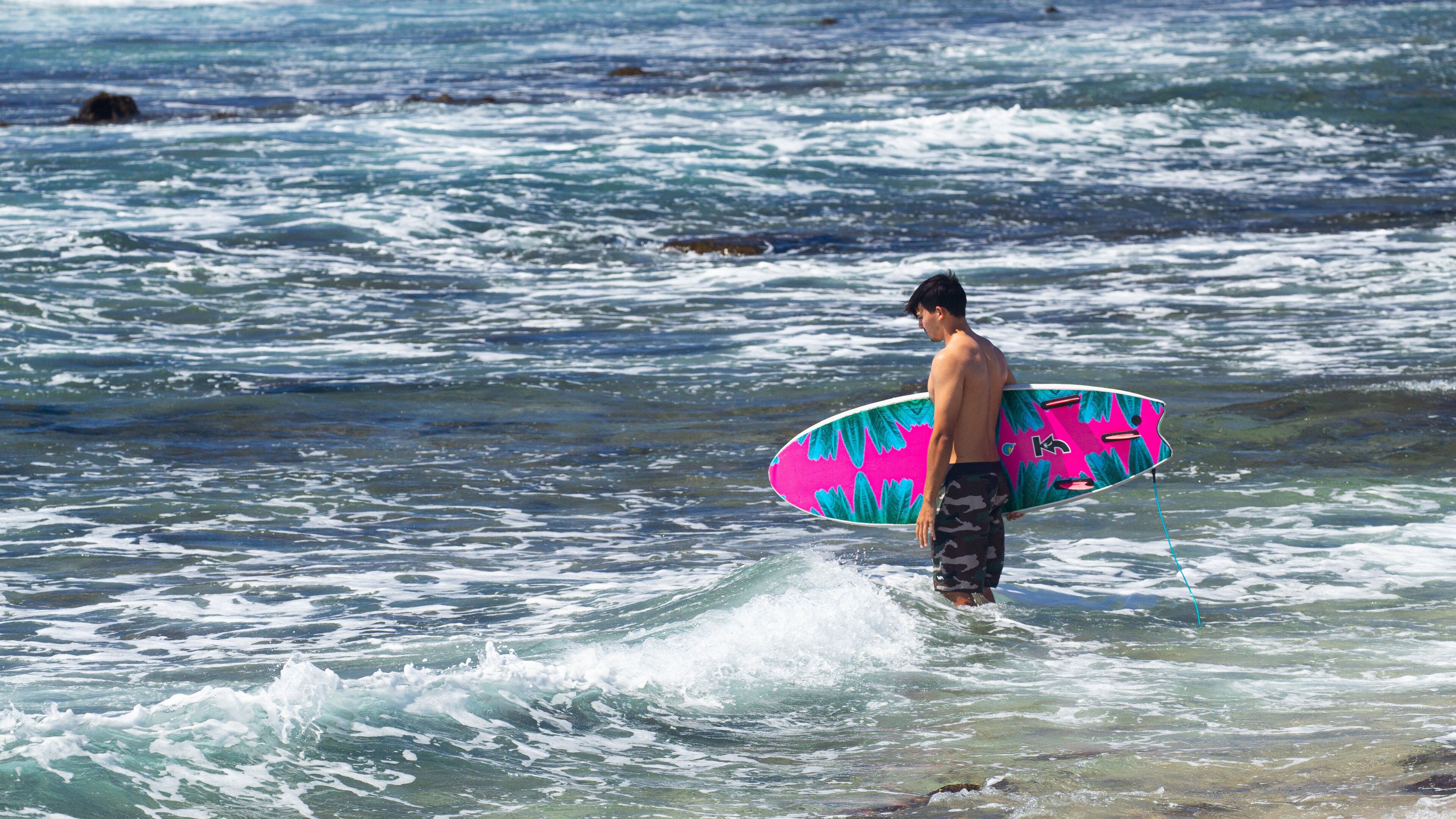 Old Kona Airport State Recreation Area showing surfing and general coastal views as well as an individual male