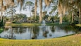Palm Harbor Golf Club featuring a pond and a fountain