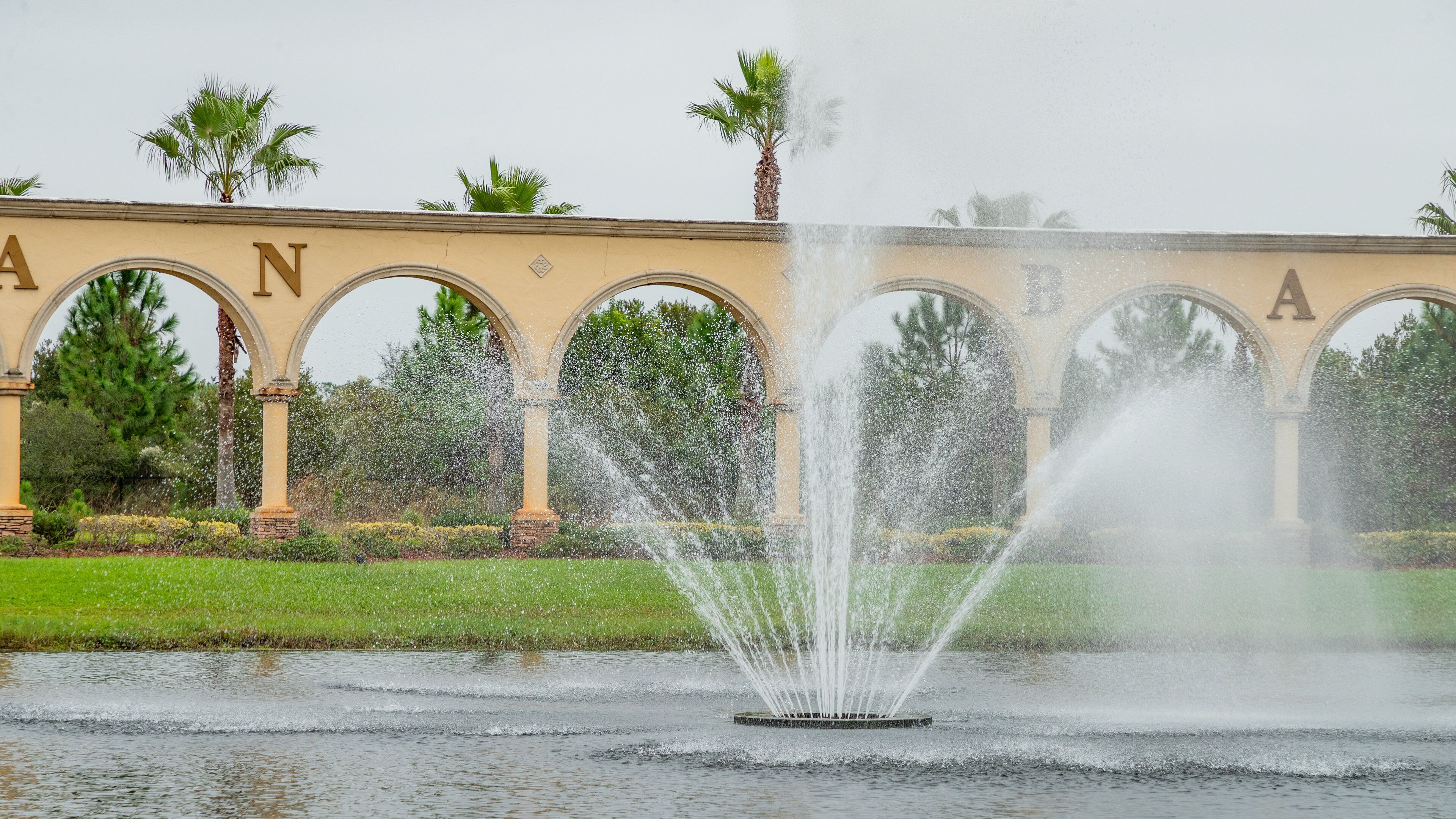 Venetian Bay Golf Club showing a fountain, a park and signage