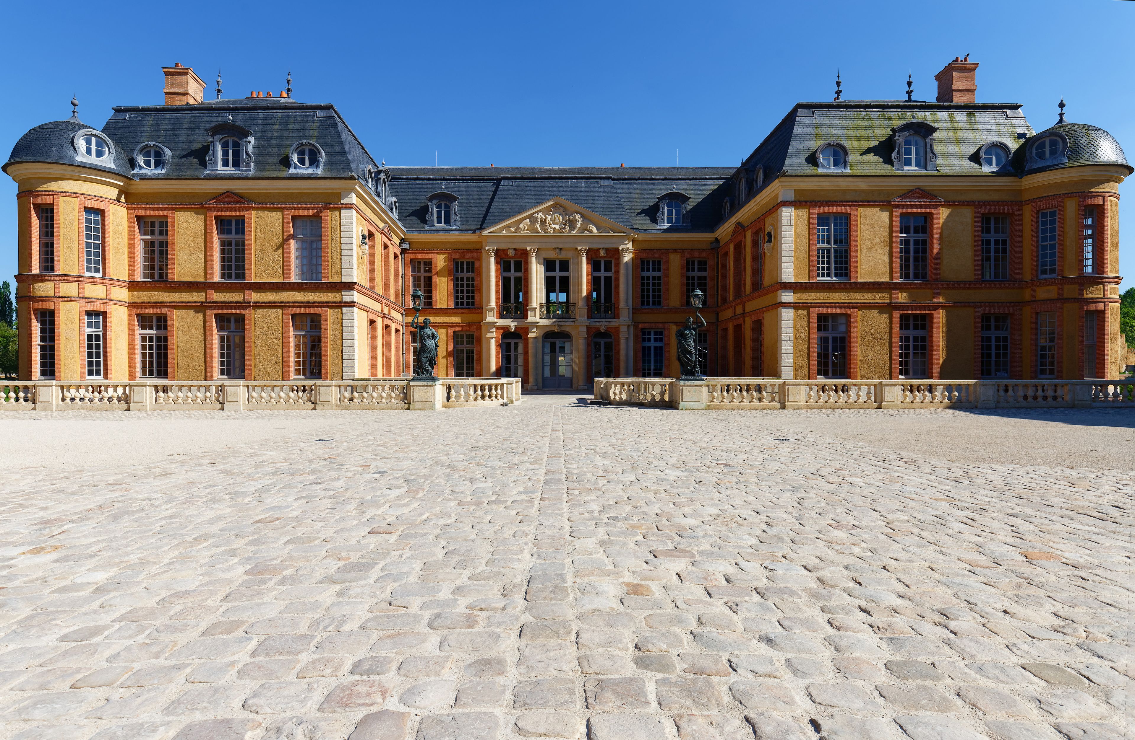 A grand historic building with a symmetrical facade, large windows, and a central entrance.