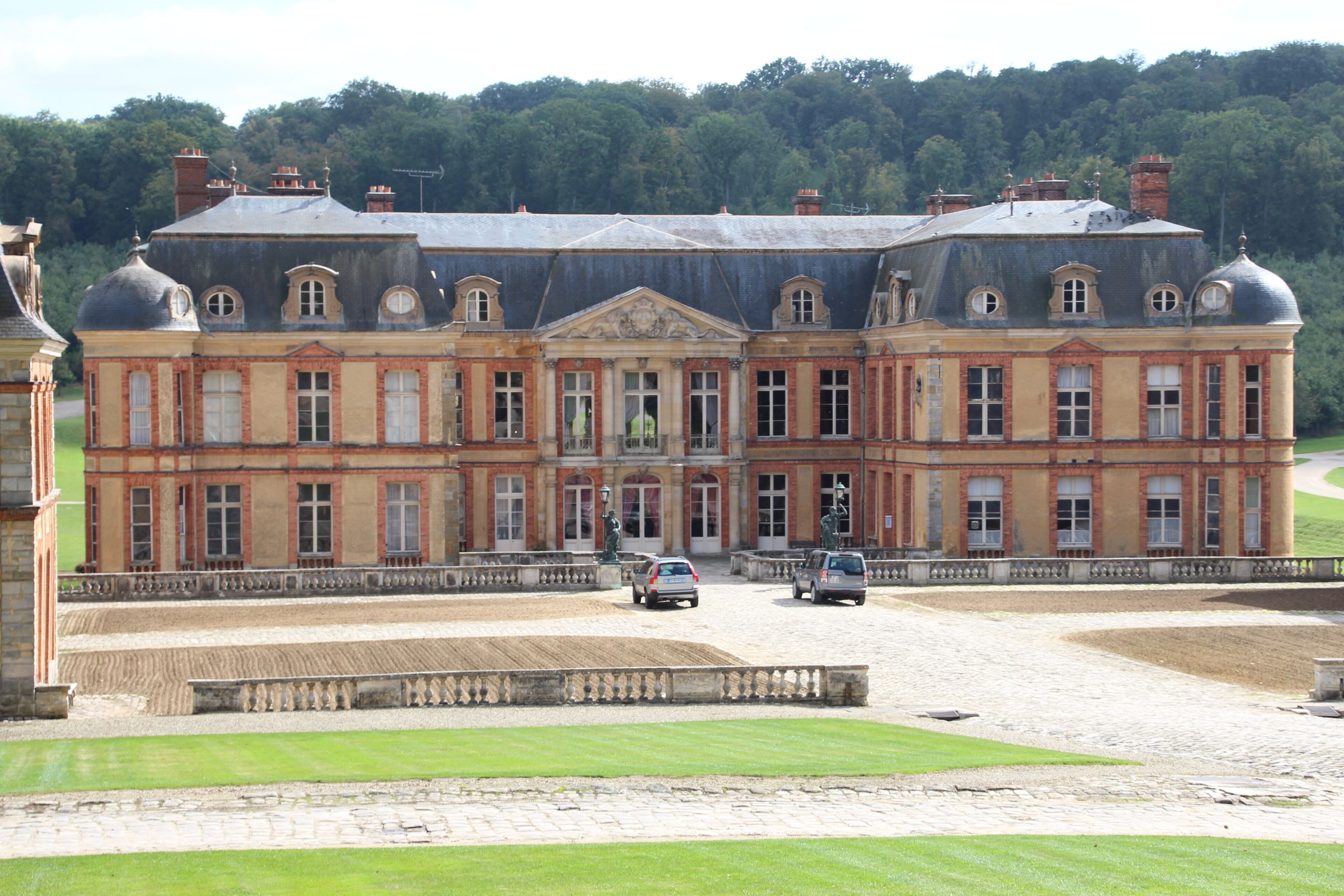 A large, historic building with a symmetrical facade, multiple windows, and a central entrance.